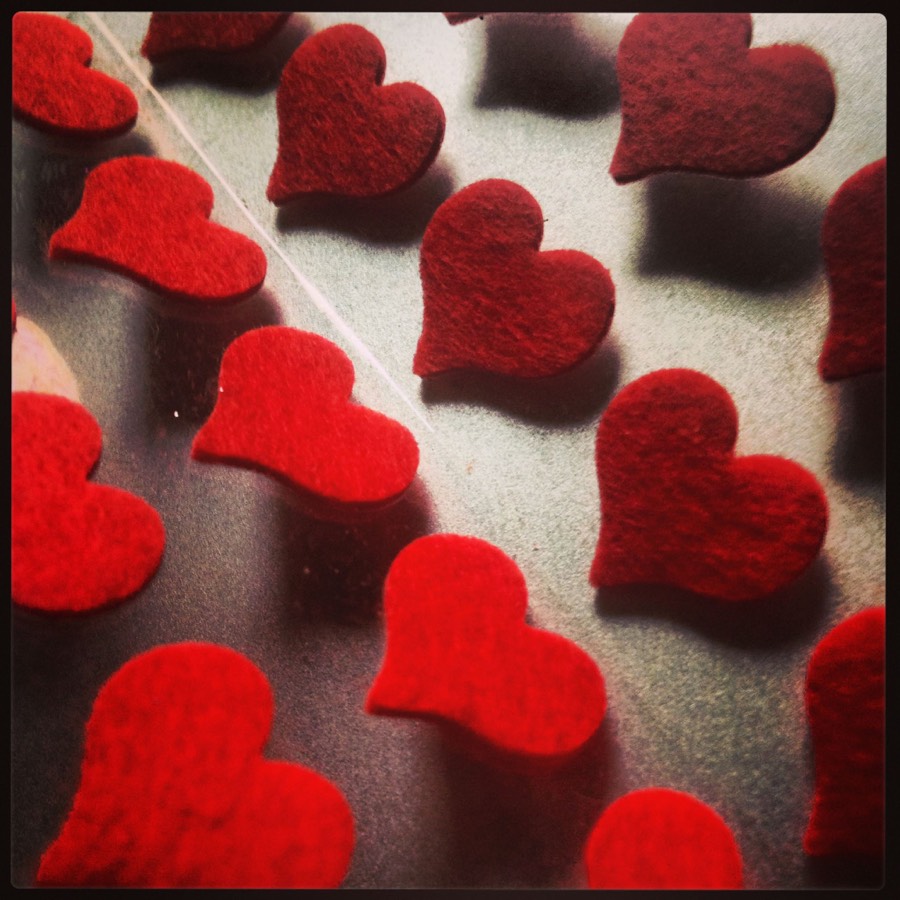 A tray of small red felt hearts.