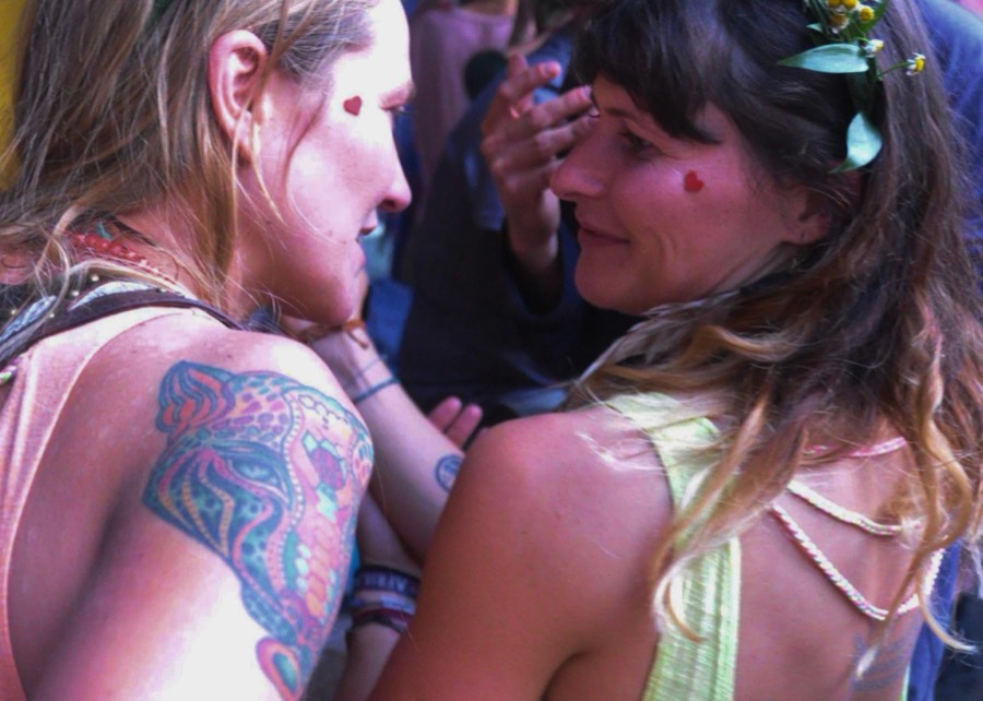 Two members forehead to forehead with red felt hearts on their cheeks.